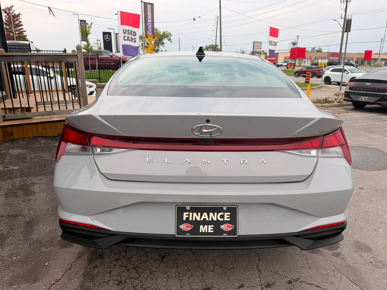 2022 Hyundai Elantra SEL Gray rear exterior view showing red taillights and "Finance Me" license plate at dealership lot.