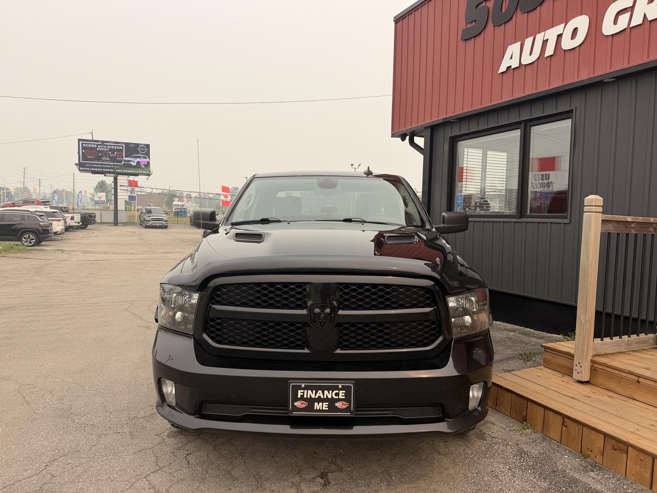 2021 RAM 1500 Classic Pickup Truck Black front exterior view at dealership lot with distinctive grille and Finance Me license plate.