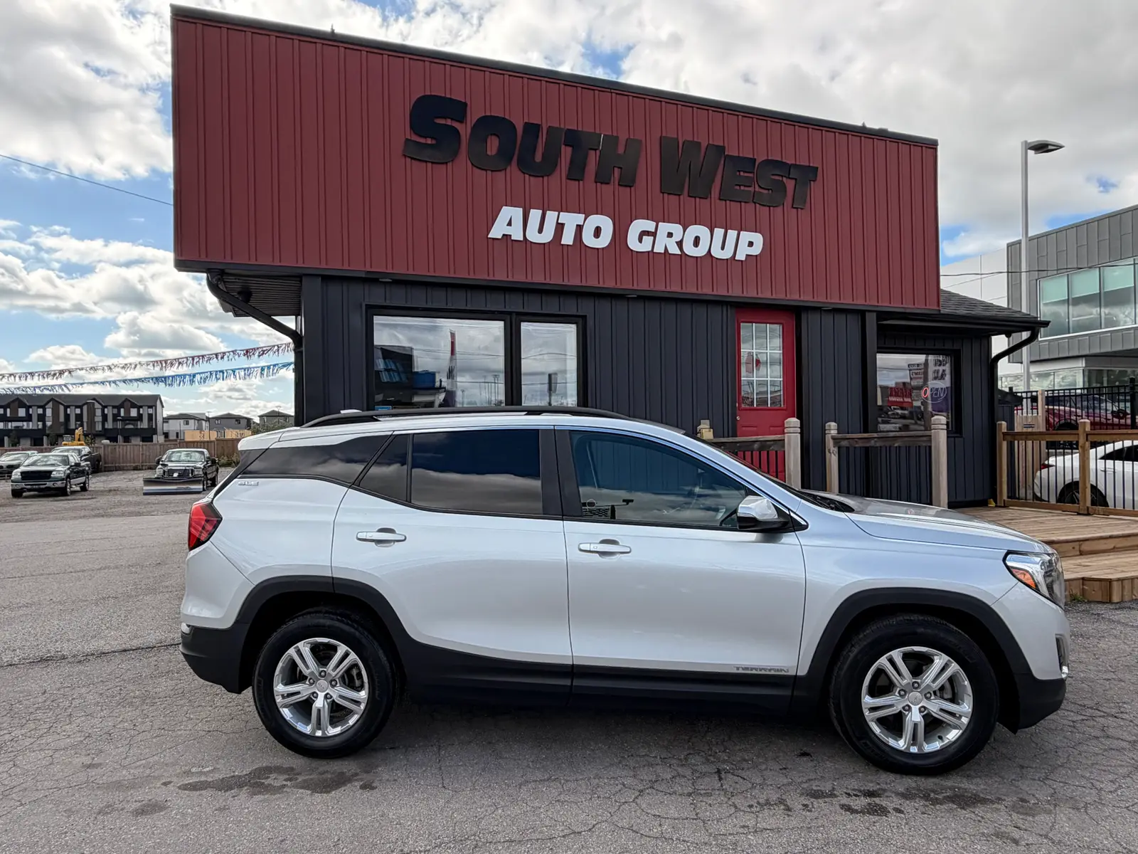 2021 GMC Terrain SLE Gray exterior side view with polished alloy wheels parked at South West Auto Group dealership.