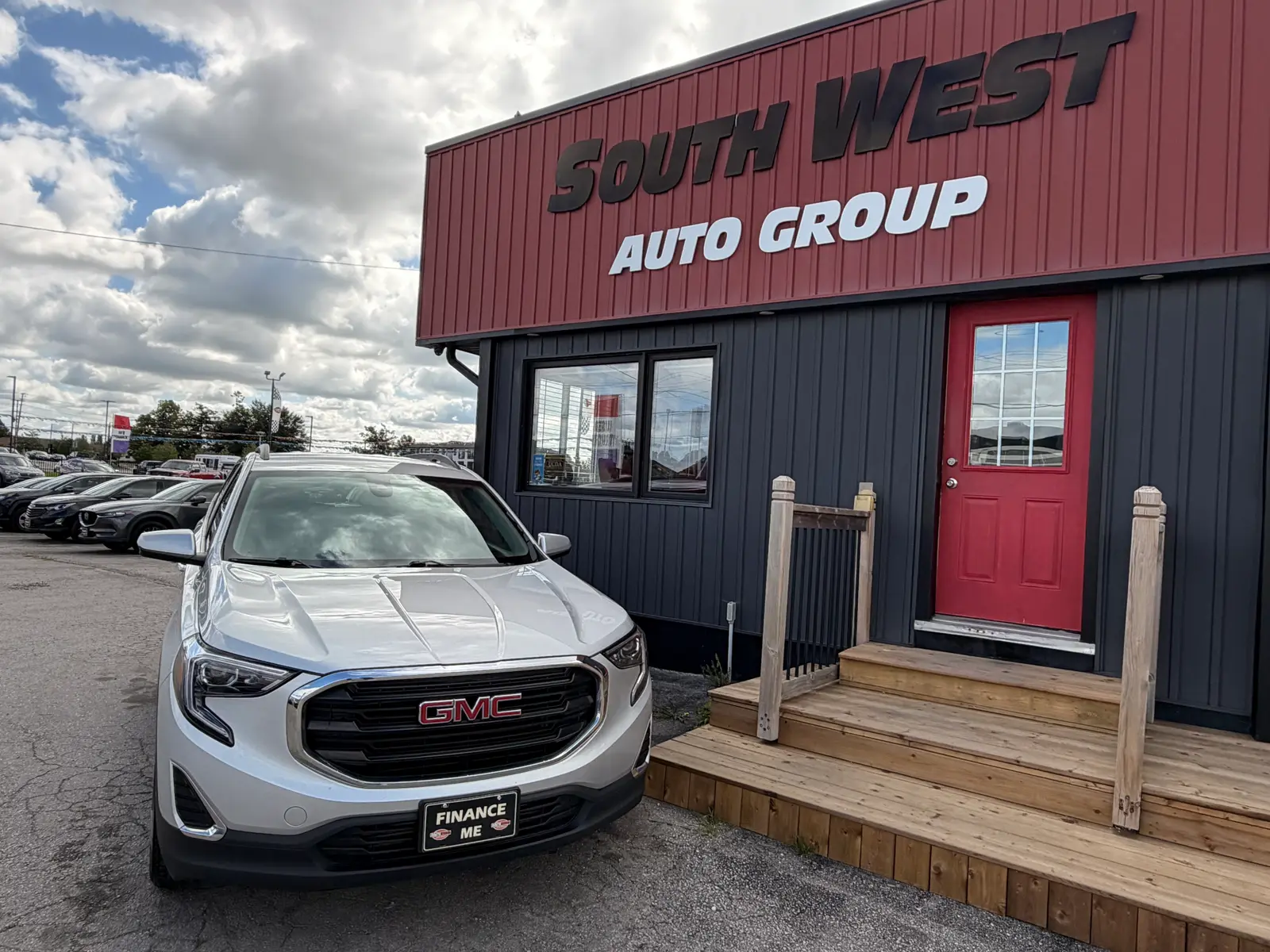 2021 GMC Terrain SLE Gray front three-quarter exterior view parked at South West Auto Group dealership with "Finance Me" license plate visible.