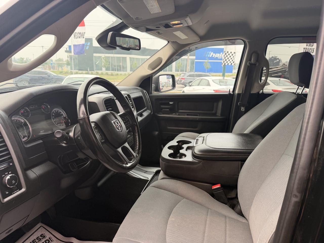2021 RAM 1500 Classic Pickup Truck Black interior cabin view with two-tone gray and black seats and steering wheel visible.