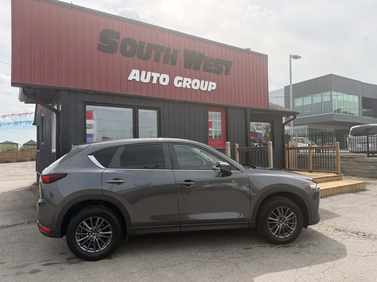 2020 Mazda Cx-5 Touring Gray side profile exterior view with alloy wheels parked at South West Auto Group dealership.