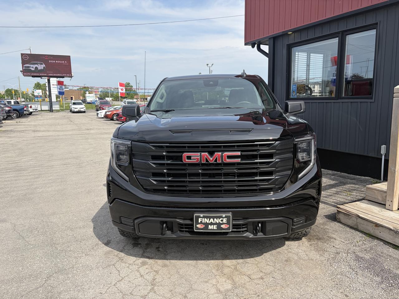 2023 GMC Sierra 1500 Pickup Truck Black front exterior view at dealership with prominent grille badging and finance plate visible.