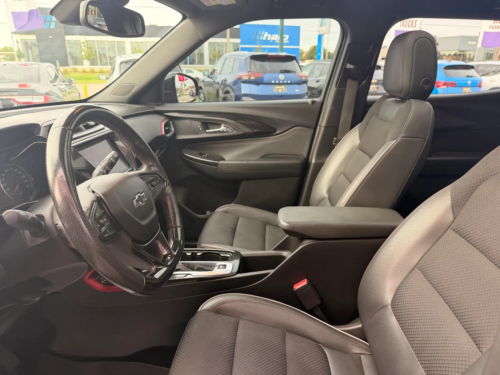 2021 Chevrolet Trailblazer RS Red interior view showing gray leather seats, steering wheel, and dashboard from driver's side.