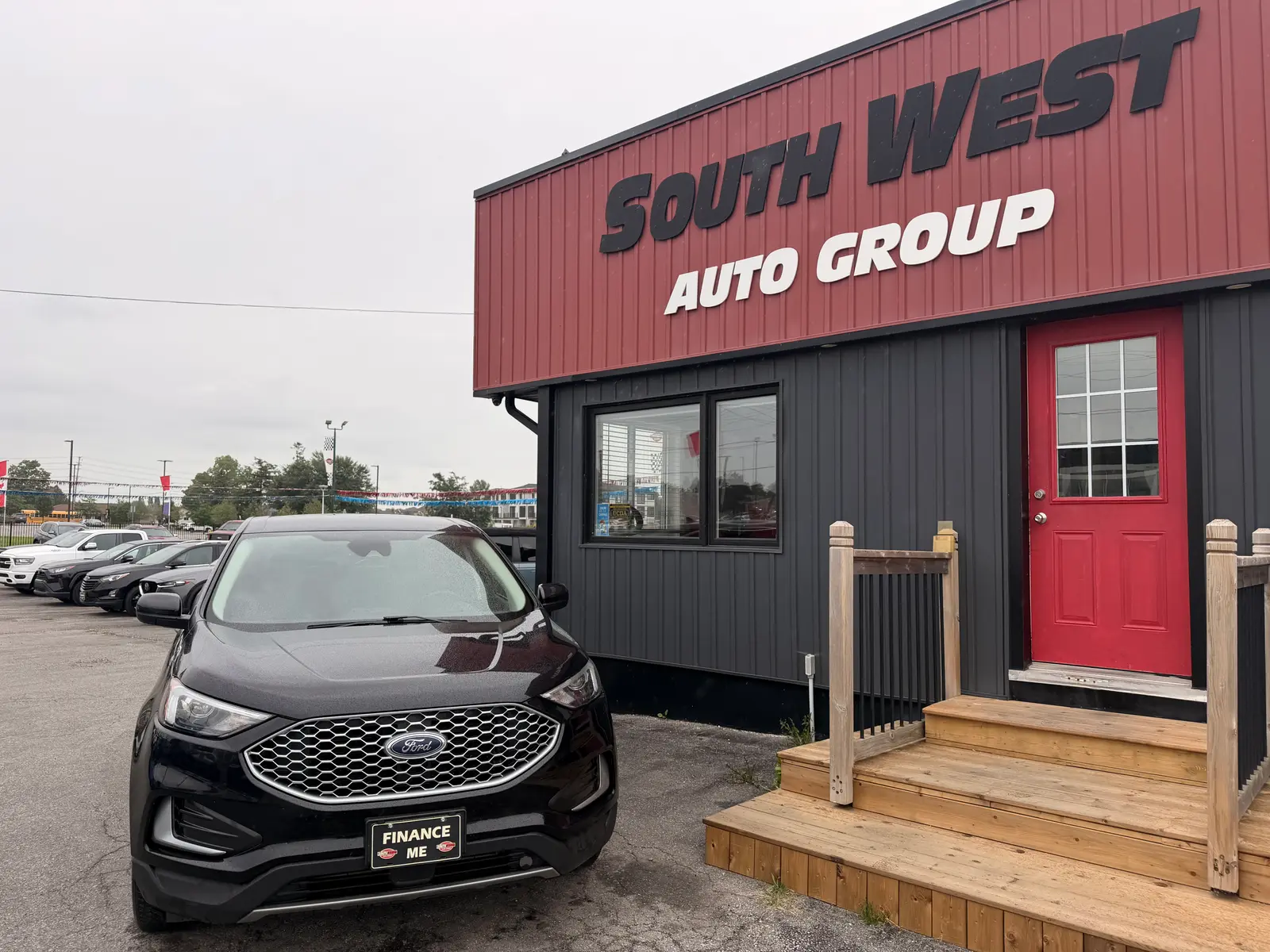 2023 Ford Edge SEL Black front three-quarter exterior view parked at South West Auto Group dealership with Finance Me license plate visible.