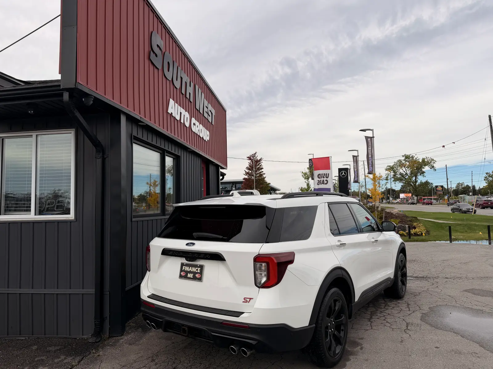 2020 Ford Explorer ST White rear three-quarter exterior view with ST badging, displayed at auto dealership lot with finance signage visible.