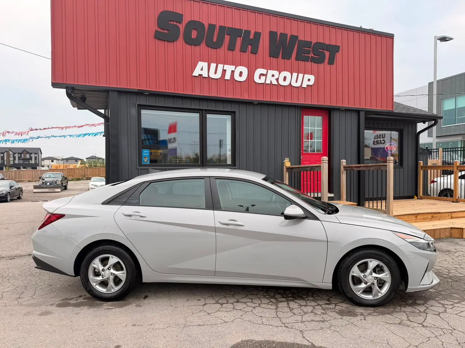 2022 Hyundai Elantra SEL Gray exterior side view parked at dealership with alloy wheels and tinted windows visible.