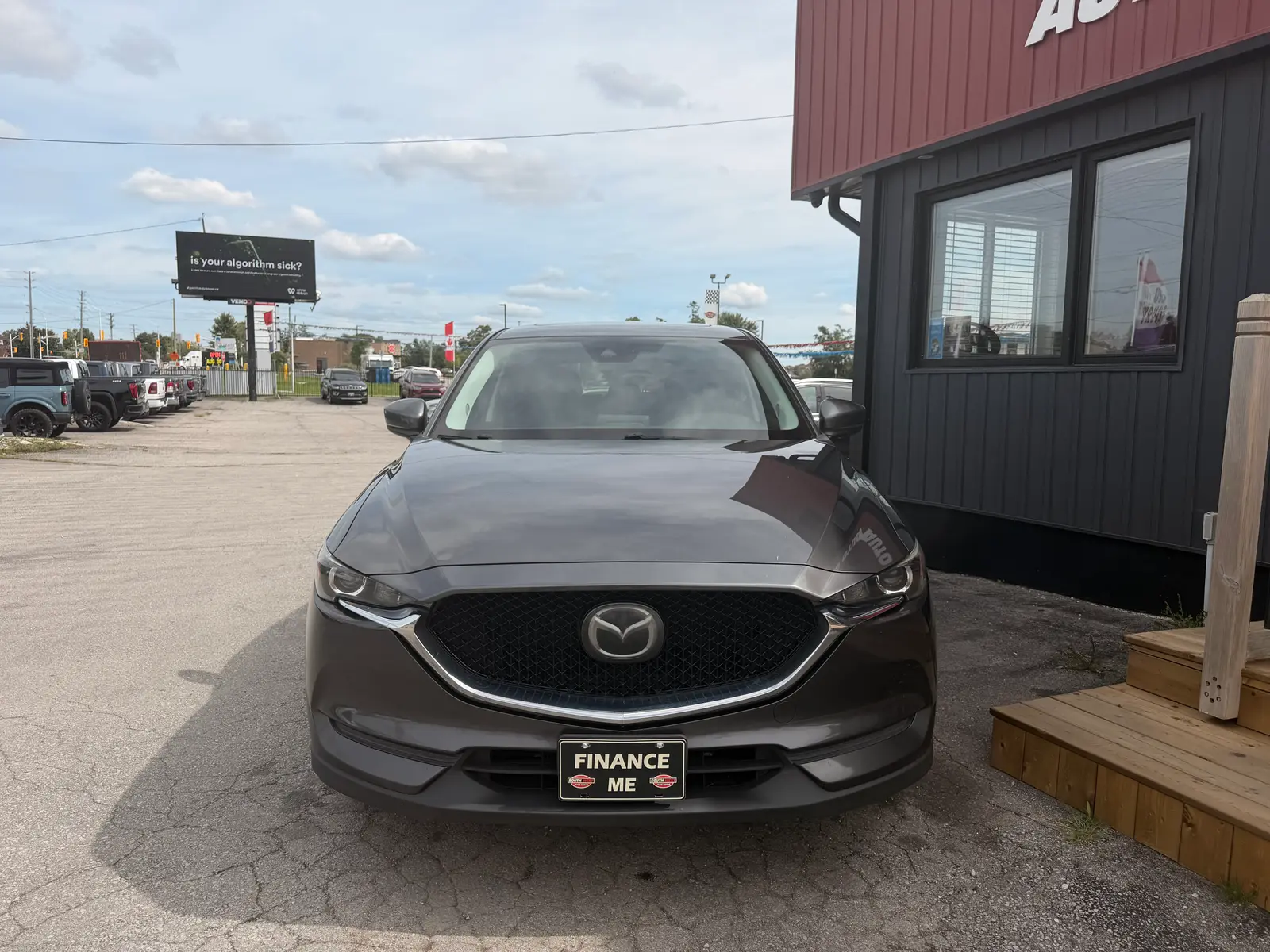 2020 Mazda Cx-5 Touring Gray front exterior view parked at dealership with "Finance Me" license plate visible.