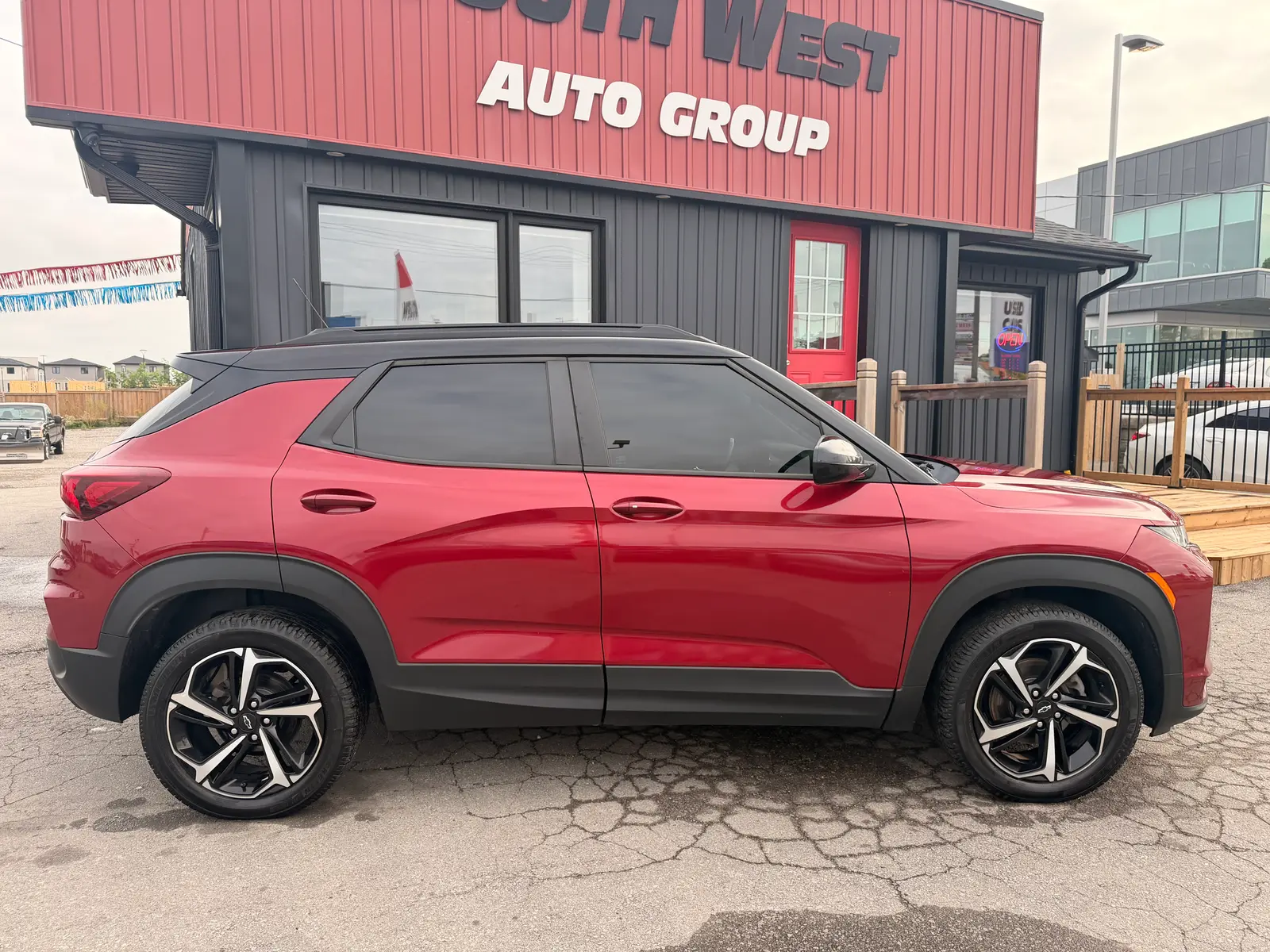 2021 Chevrolet Trailblazer RS Red driver side exterior view with black two-tone cladding and distinctive multi-spoke alloy wheels.