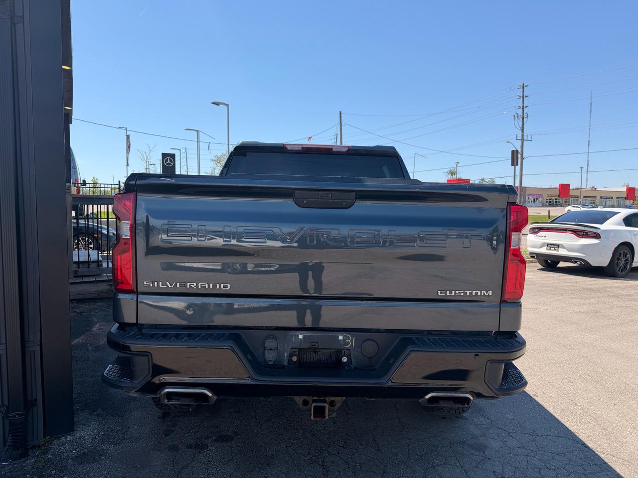 2019 Chevrolet Silverado 1500 Pickup Truck Black rear exterior view with Custom badging and dual exhaust outlets visible.