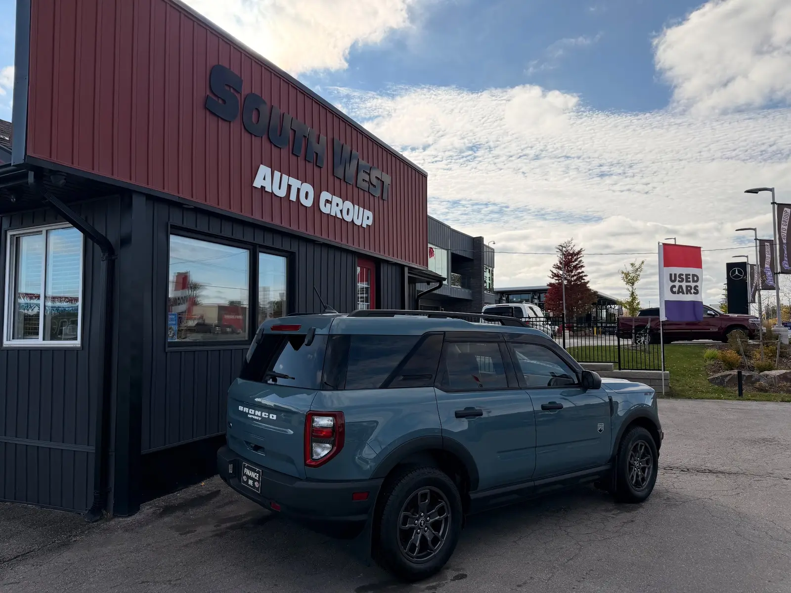 2021 Ford Bronco Sport Big Bend Blue rear three-quarter exterior view showing alloy wheels and taillights at dealership lot.