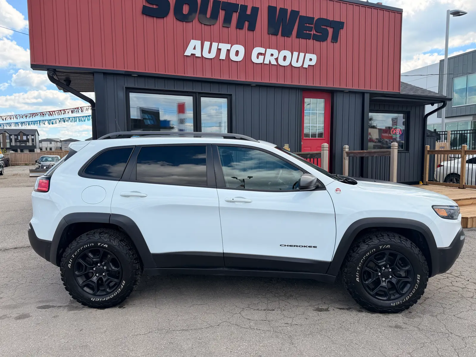 2021 Jeep Cherokee Trailhawk White driver side exterior view with black BFGoodrich all-terrain tires and two-tone body styling.